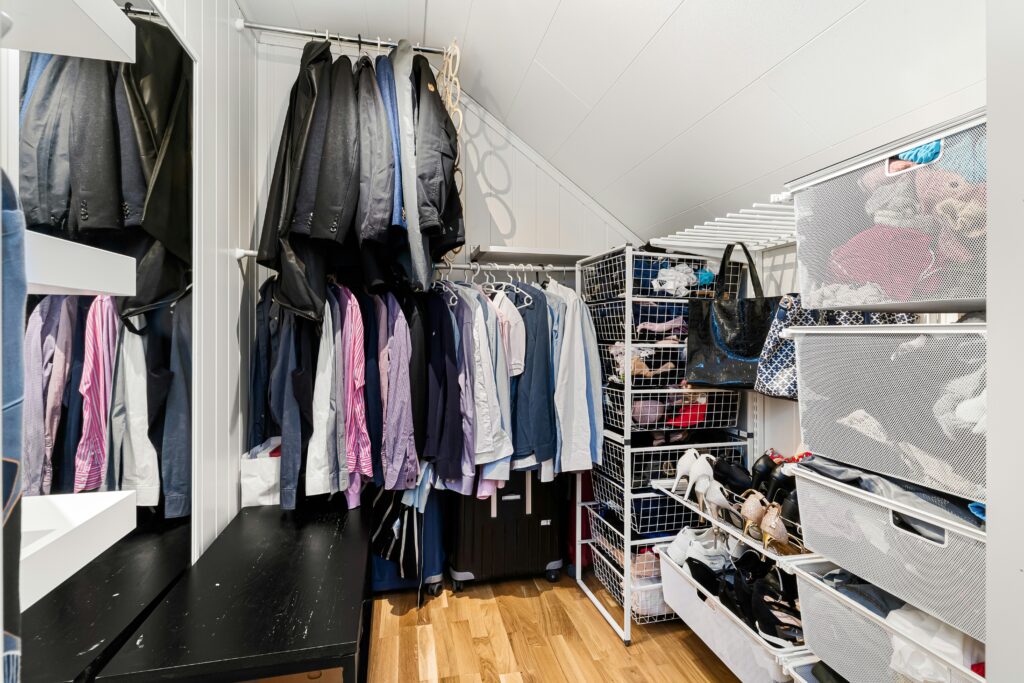 Open closet wall with wire grid organizer holding shoes, handbags, and accessories — ideal for visualizing small-space accessory storage solutions